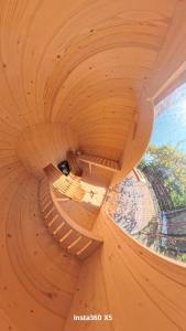 a wooden spiral staircase in a wooden building at Beloviski raj 