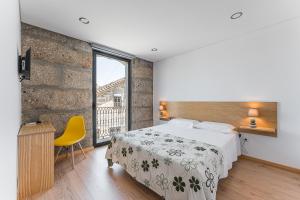 Ένα ή περισσότερα κρεβάτια σε δωμάτιο στο Sevenfarm Turismo Rural