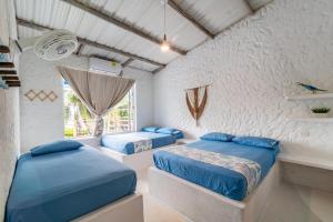 a bedroom with two beds and a window at Kuruba Beach in Rincón