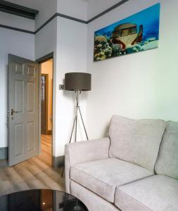 a living room with a couch and a painting on the wall at 1BR Harbor Apartment , Family-Friendly , Sleeps 4 in Folkestone