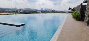 a large swimming pool in the middle of a city at Lux Homey Sunway Gandaria in Bandar Baru Bangi