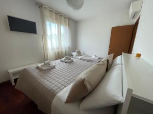 a bedroom with a bed with two towels on it at Mattei13 in Bologna