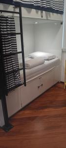 a bottom bunk of a bunk bed with a ladder at HBB Hostel Brasil Bar- Vila Madalena - São Paulo-SP - Próximo a Beco do Batman, Paulista, Allianz Parque, Morumbi, Acesso 24hs in São Paulo