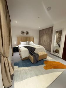 a bedroom with a large bed with a blue rug at 1bed with pool and restaurant apartment in Accra