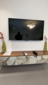 a flat screen tv hanging on a wall at 1bed with pool and restaurant apartment in Accra