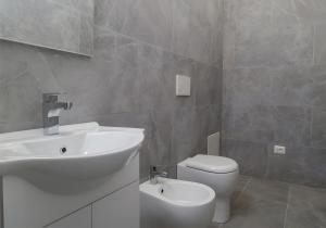 a bathroom with a sink and a toilet at Villa Etna in Castiglione di Sicilia +7 photos