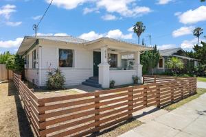 a house with a wooden fence in front of it at Walk to Beach and Restaurants - Super Clean! in Long Beach