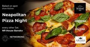 a pizza with pepperoni and basil on a plate at ODAYA Social Hotel Bansko in Bansko