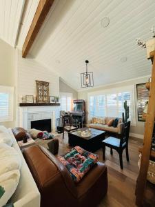 a living room with a couch and a fireplace at Endless Summer Beach House in Huntington Beach