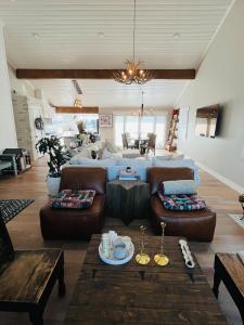 a living room with a couch and a table at Endless Summer Beach House in Huntington Beach