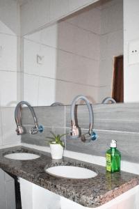two sinks in a bathroom with two faucets at Casa Grau in Sucre +53 photos