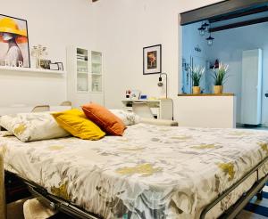 a bedroom with a large bed with colorful pillows on it at Live As Florentine in Florence