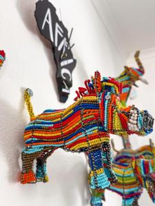 a colorful wooden toy horse on a wall at Dung Beetle Bush Villa in Marloth Park