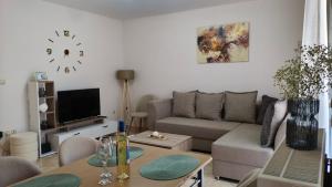 a living room with a couch and a table at PERLA apartment in Alexandroupoli