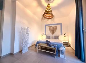 a bedroom with a bed and a chandelier at Salento astrea vista mare in Porto Cesareo