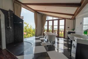 a bathroom with two sinks and a large window at Royal Majestic Grand Thai Villa in Choeng Mon Beach