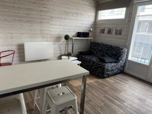 a living room with a couch and a table at Studio hyper centre Pornichet in Pornichet
