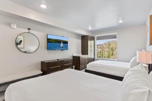 ein Hotelzimmer mit zwei Betten und einem Fernseher in der Unterkunft Luxury Black Rock Resort Suite Unit B in Heber City