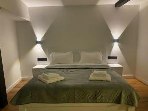 a bedroom with a bed with two towels on it at Charming Historic Apartment F2 in Tbilisi City