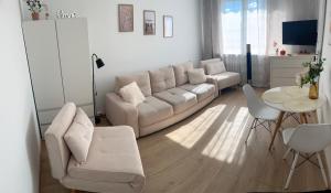 a living room with a couch and a table at Mieszkanie blisko morza Gdańsk Stogi in Gdańsk