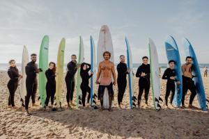 a group of people standing in front of their surfboards at Cozy Guesthouse in Aourir near Tamraght in Aourir