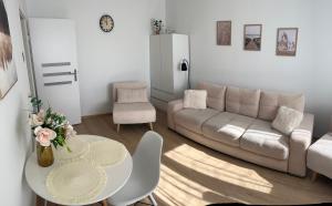 a living room with a couch and a table at Mieszkanie blisko morza Gdańsk Stogi in Gdańsk