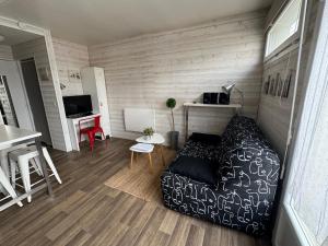 a living room with a couch and a table at Studio hyper centre Pornichet in Pornichet