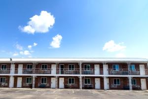 a large white building with balconies and a blue sky at Imperial Inn Tazewell in Tazewell