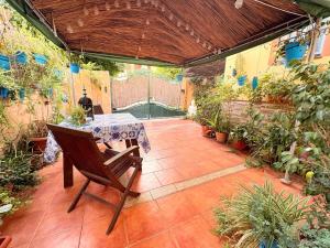 a patio with a table and some potted plants at Cool Garden Sevilla Aljarafe in Mairena del Aljarafe