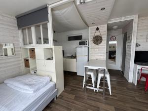 a bedroom with a bed and a desk and a table at Studio hyper centre Pornichet in Pornichet