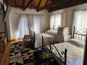a bedroom with two beds and a checkered floor at Casa de campo Aconchego Serrano in Lages