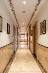 a hallway with a row of doors and a ceiling at Hotel Atlantiis Suites Near Kashi Vishwanath temple in Varanasi