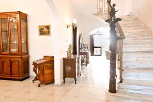 a hallway with a staircase with a wooden cabinet at Mediterranean Villa in St. Paul's Bay +35 photos