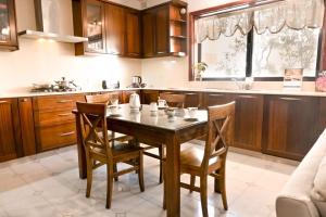 a kitchen with a wooden table and chairs at Mediterranean Villa in St. Paul's Bay