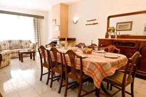 a dining room with a table with chairs and a mirror at Mediterranean Villa in St. Paul's Bay
