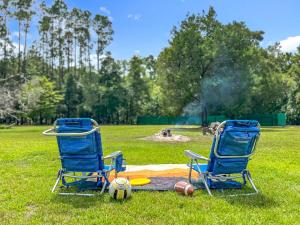 zwei Stühle und eine Decke auf einem Feld mit Bällen in der Unterkunft Cabin Retreat on 8.5 Acres at High Springs, FL in High Springs