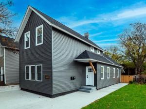 a gray house with a white door at Unique BOHO Ohio City Loft Apt in Ohio City