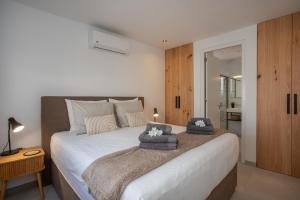 a bedroom with a bed with two hats on it at Zon&zo Luxurious Apartment in Jan Thiel in Jan Thiel +32 photos