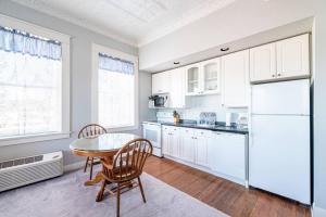 a kitchen with a table and a white refrigerator at The Dallas Apartment in Eastland