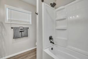 a white bathroom with a shower and a window at The Boji Anchor off East Lake in Arnolds Park +26 photos