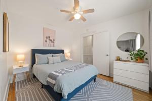 a bedroom with a bed and a ceiling fan at Walk To Beach Restaurants - 5 Guests in Long Beach +70 photos