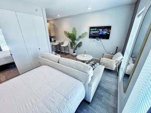 a living room with two couches and a tv at Cloud Nine Studio in Des Moines