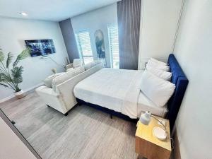 a bedroom with a large bed and a couch at Cloud Nine Studio in Des Moines