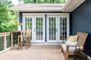 a patio with a white door and chairs on a deck at Heron House-ON Lake Avalon - near MTB in Bella Vista