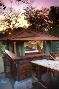 a gazebo with a roof on top of it at Baghvan Pench National Park - A Taj Safari Lodge in Behrai