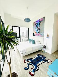 a bedroom with a white bed and a potted plant at Picasso Sky Penthouse in Miami