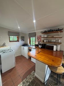 a large kitchen with a wooden counter top at Devonshire Cottage in Nottingham Road