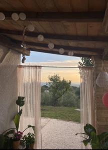 a room with a window with a view of a field at B&B La Vera Vita in Troviggiano
