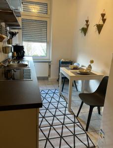 a kitchen with a table and a counter top at Business Apartment in Wiesbaden