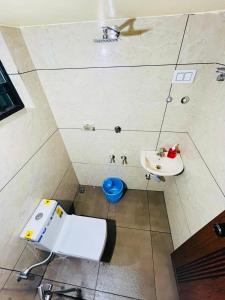 a bathroom with a toilet and a sink at Bluebell Homes in Kozhikode +16 photos
